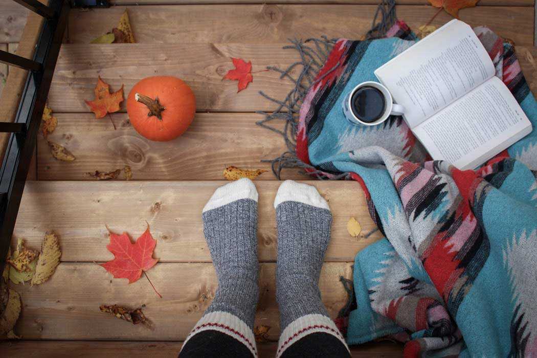 Socks on Wooden Steps with Small Pumpkin Coffee Blanket Book and Red Leaves