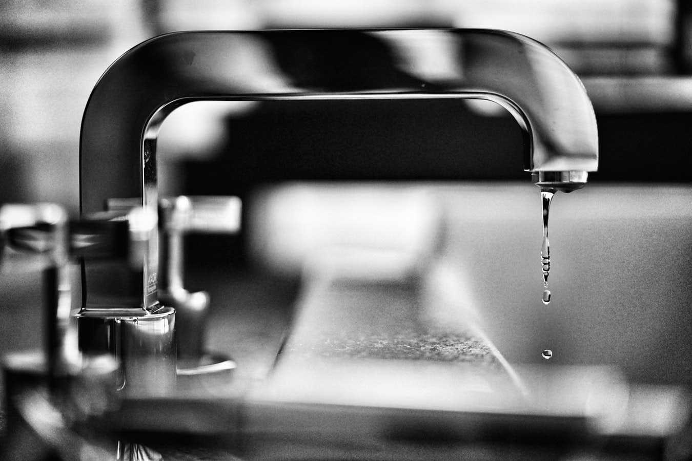 Tap in Black and White with Water Dripping