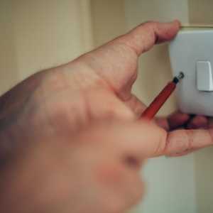 Hand Screwing in Light Switch