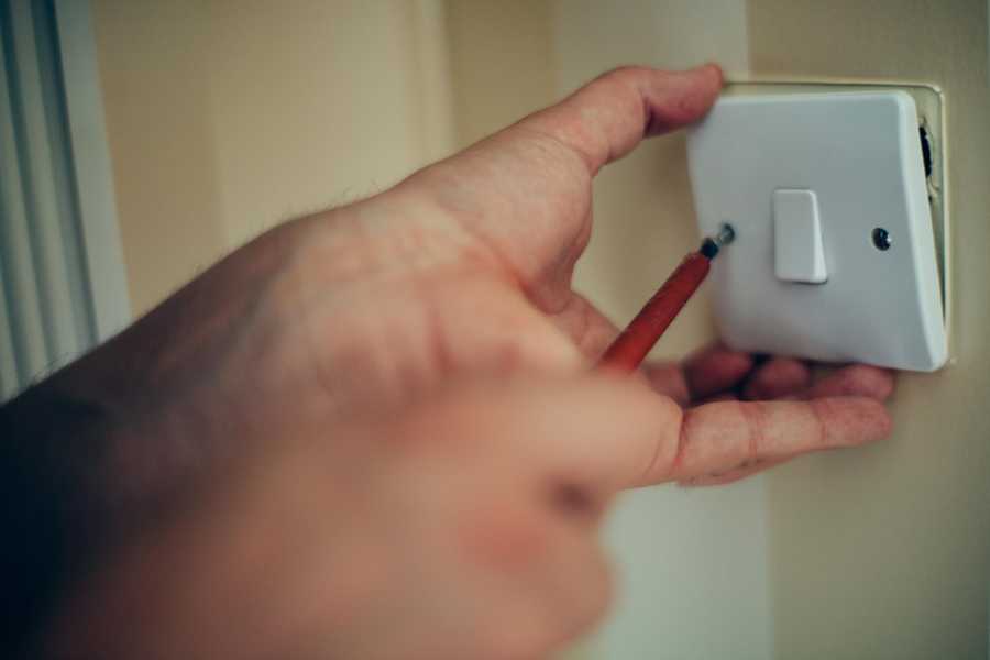 Hand Screwing in Light Switch