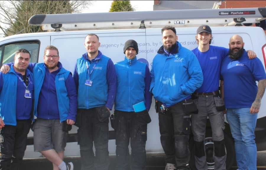 Group of Engineers in Blue Rightio Uniform Standing in Front of White Rightio Van