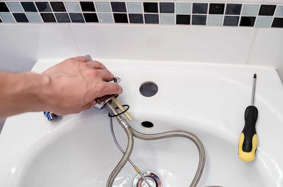 Sink with Pipes Coming from The Plug Being Repaired