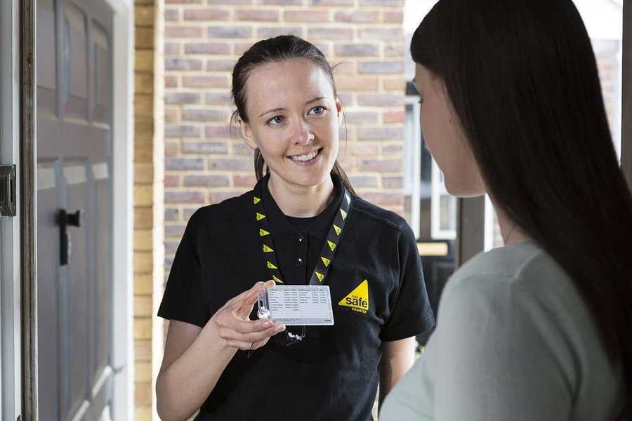 Gas Safe Engineer Showing Woman Her Gas Safe Card