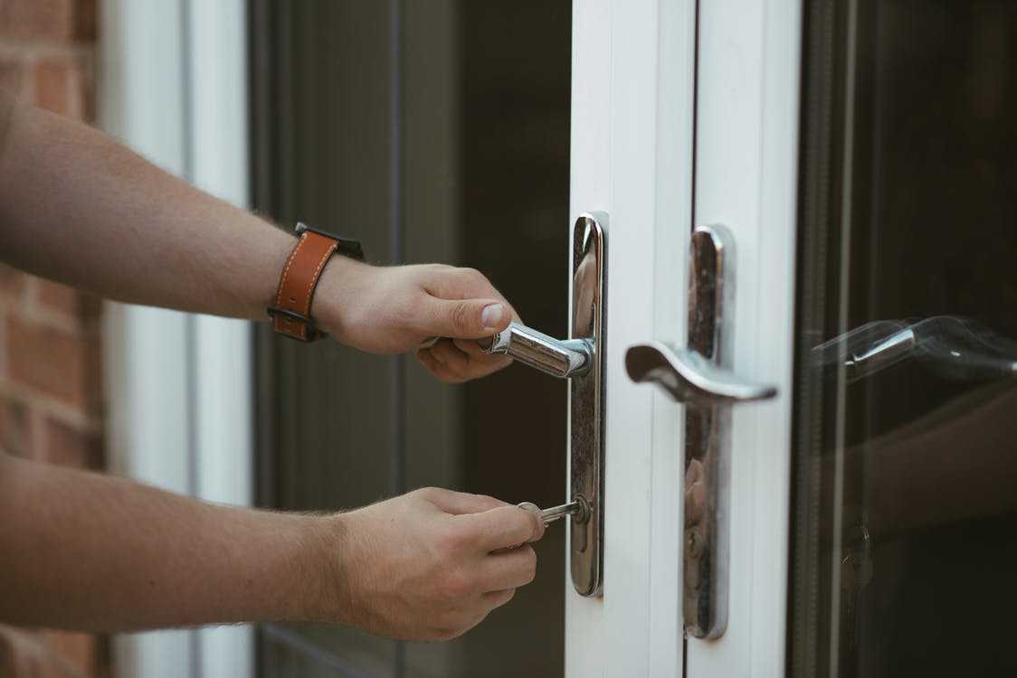 Key Going into Door with Glass Windows