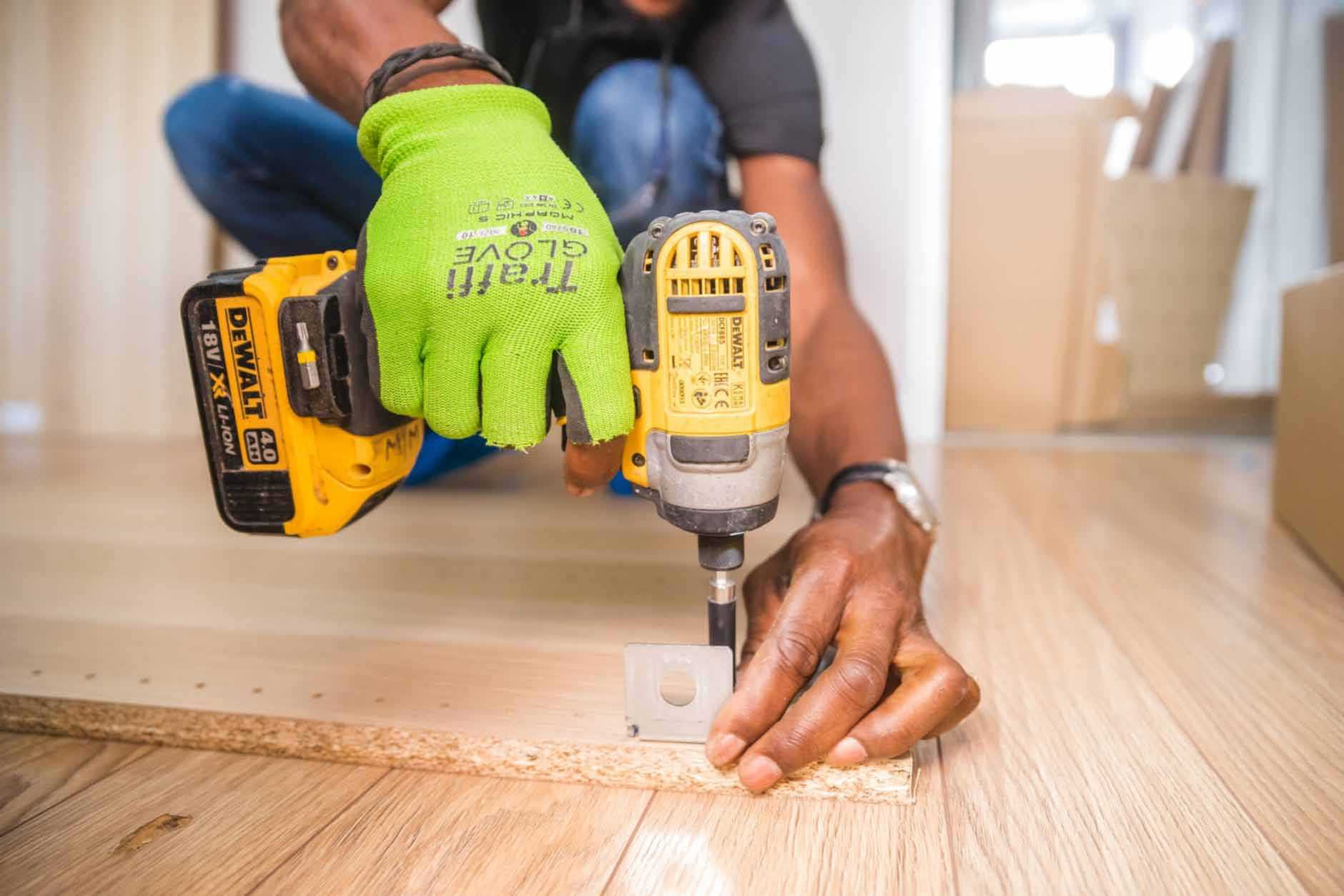 Man with Power Drill Screwing Wood
