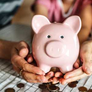 Family Holding Piggy Bank Spilling Money