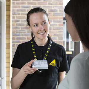 Gas Safe Engineer Showing Woman Her Gas Safe Card