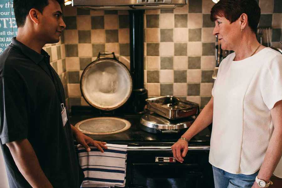 Woman Talking to Rightio Engineer in Kitchen