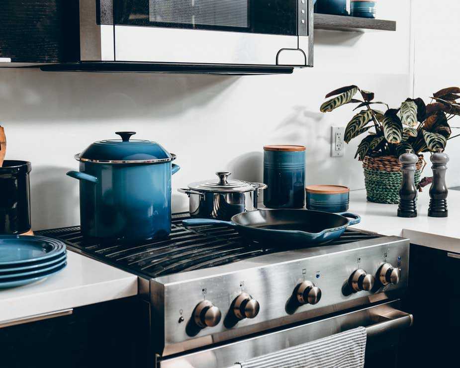 Kitchen with Oven and Blue Pots and Plates
