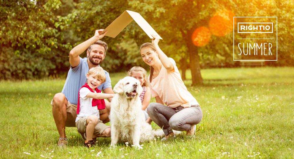 Family and Dog Holding up A Cardboard Roof