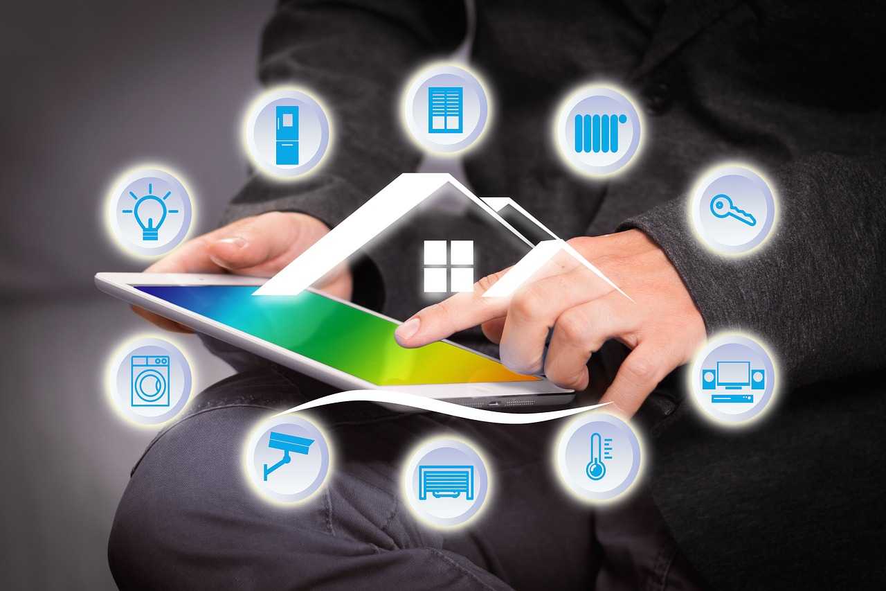 Person Pointing at Tablet with Cartoon House and Icons for Smart Home