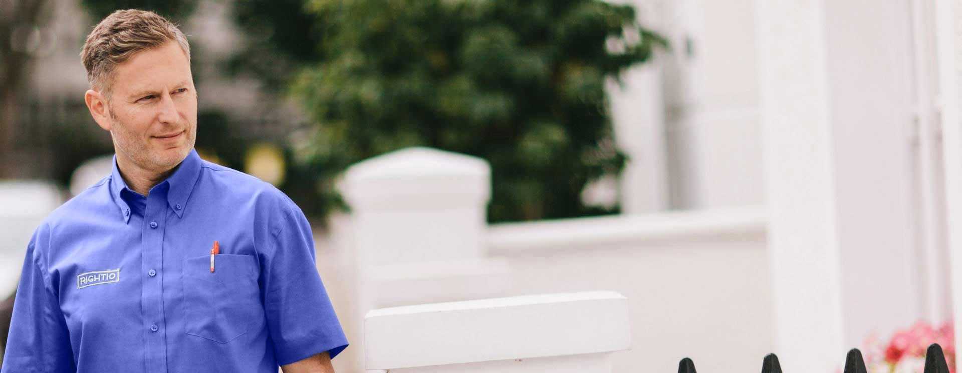 Rightio Engineer in Blue Shirt Looking to the Right Towards a White House