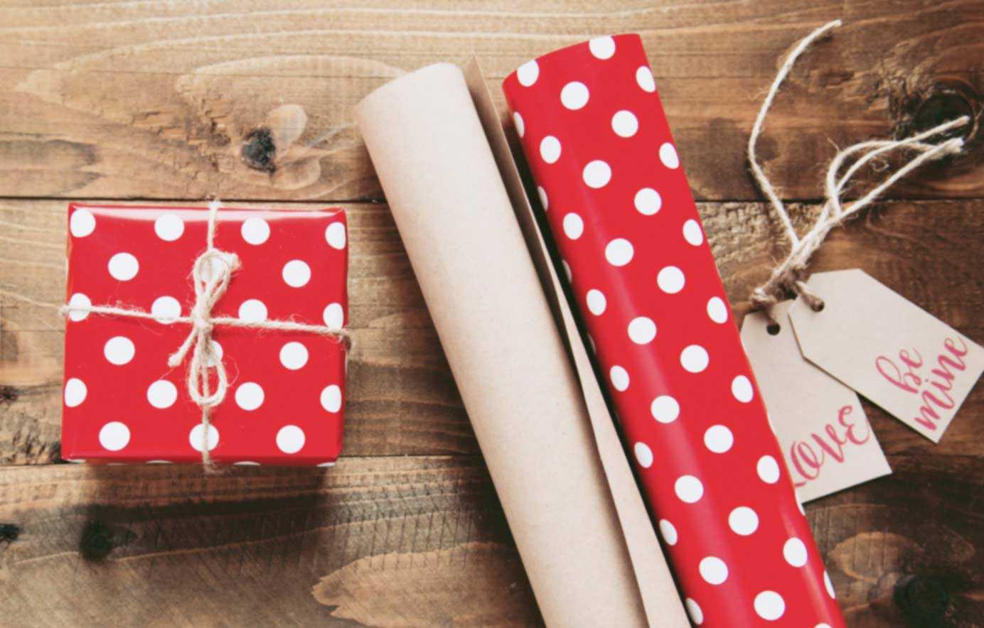 Wrapped Present Next to Red and White Polkadot Wrapping Paper