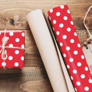 Wrapped Present Next to Red and White Polkadot Wrapping Paper