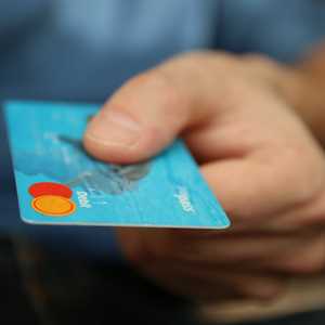 Man Holding Credit Card