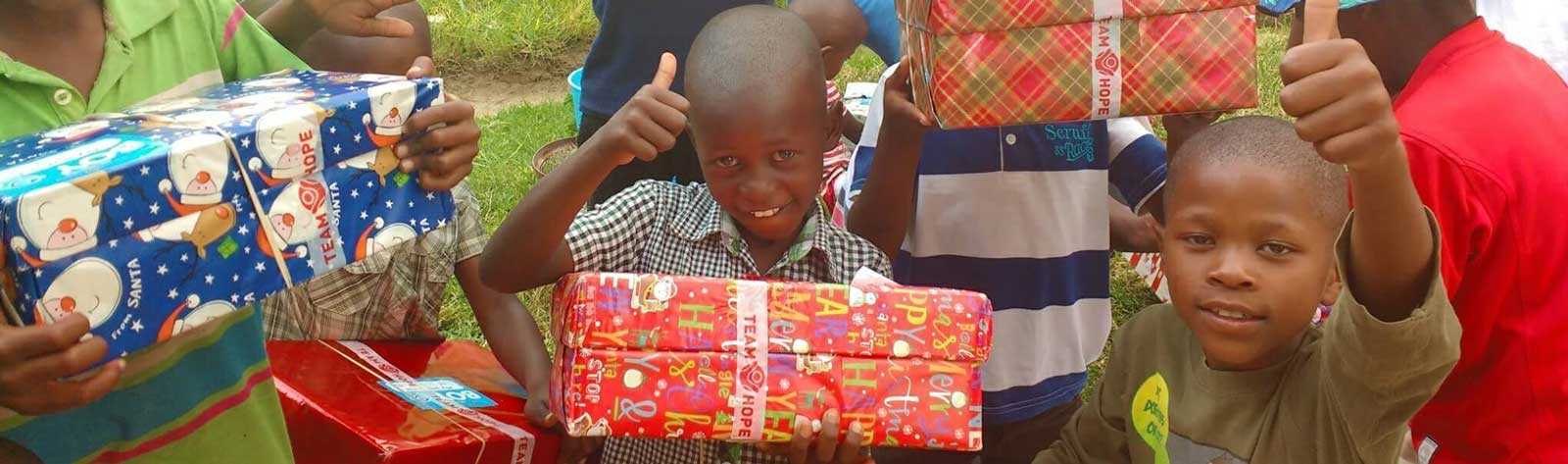 Children with Thumbs up for Team Hope Shoebox Appeal