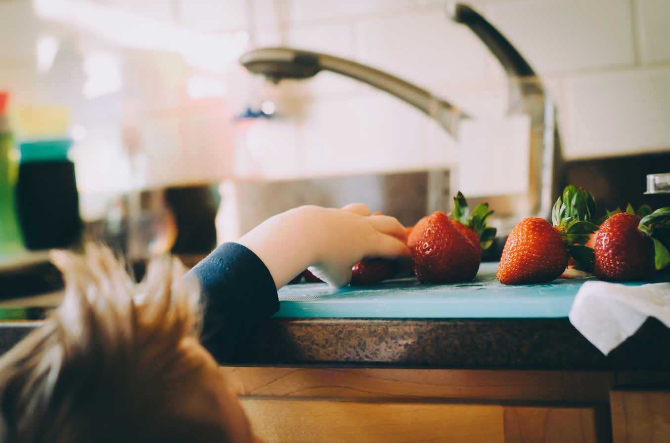 Kid Reaching for Strawberry