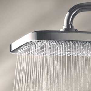a close up of a showerhead with water running