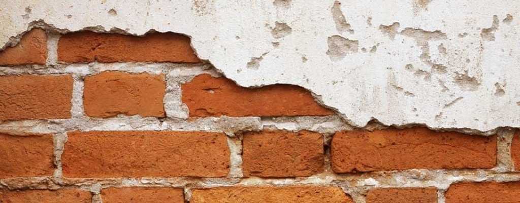 brick wall with white paint chipped 