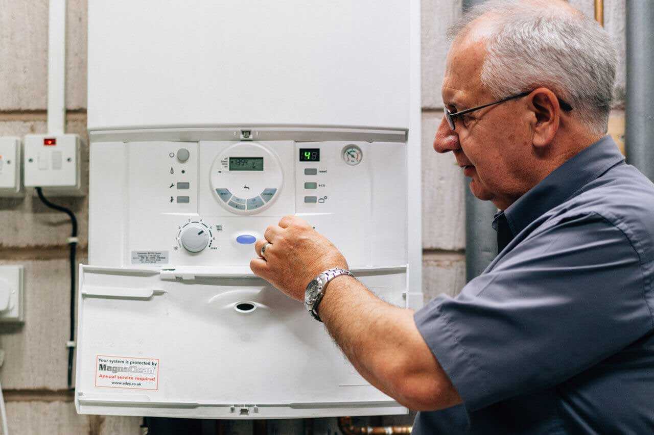 Engineer Checking Boiler with Boiler Controls