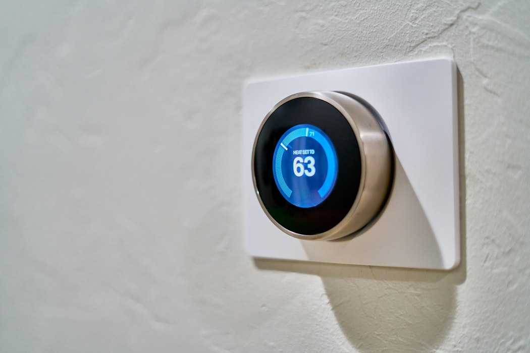 Thermostat on White Wall Showing 63